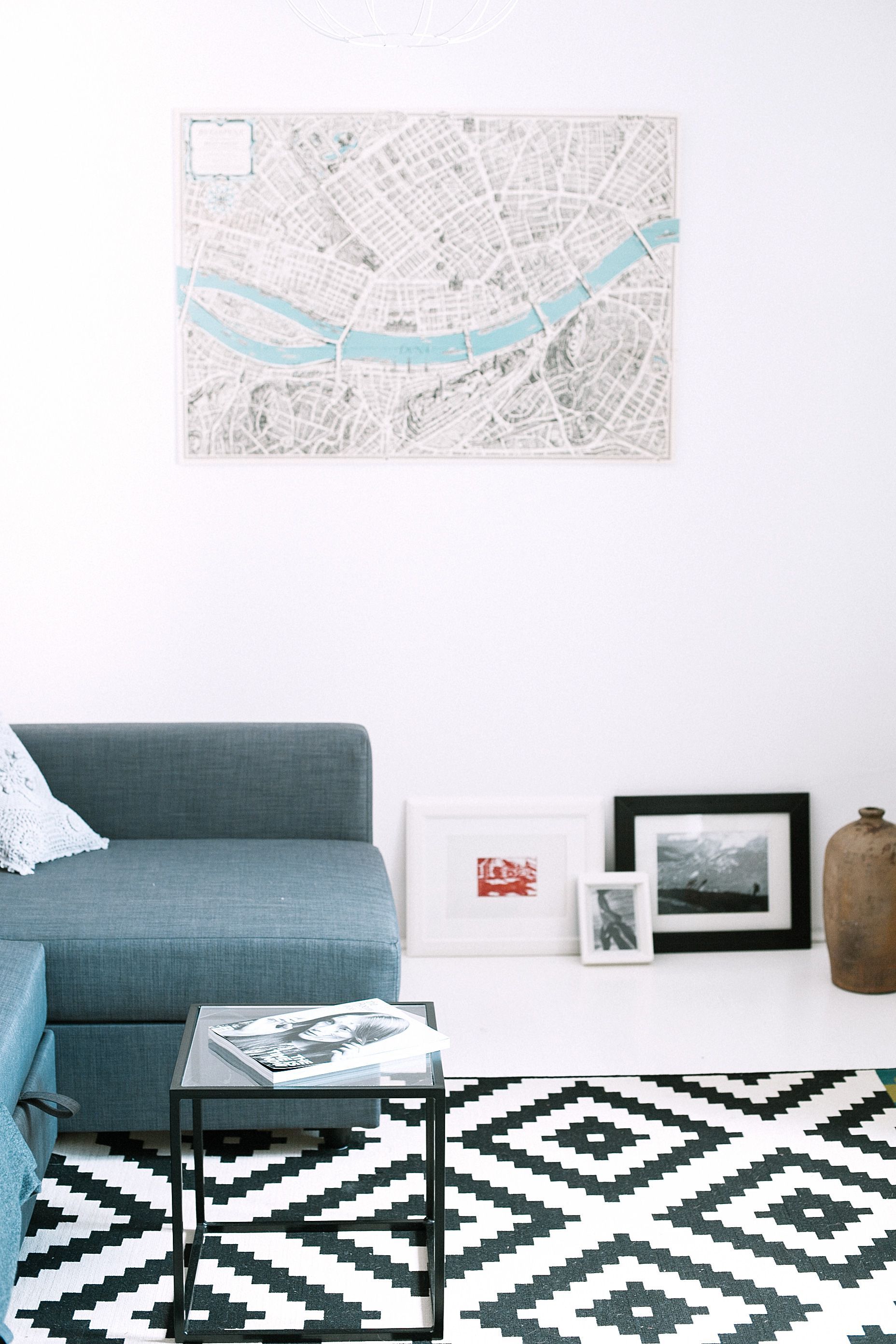 Custom Neighborhood Map hung on wall in a room with sofa and a center table.